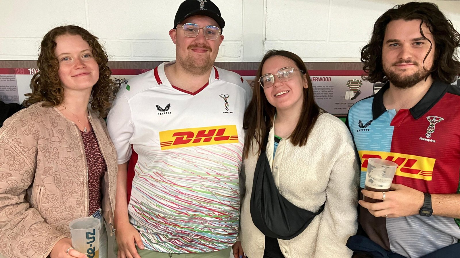 Harlequins fans pose together holding pints of beer