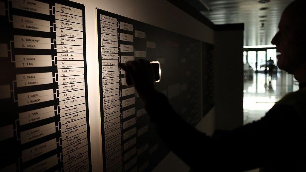 A member of the media checks the Madrid Open draw using the torch on his phone