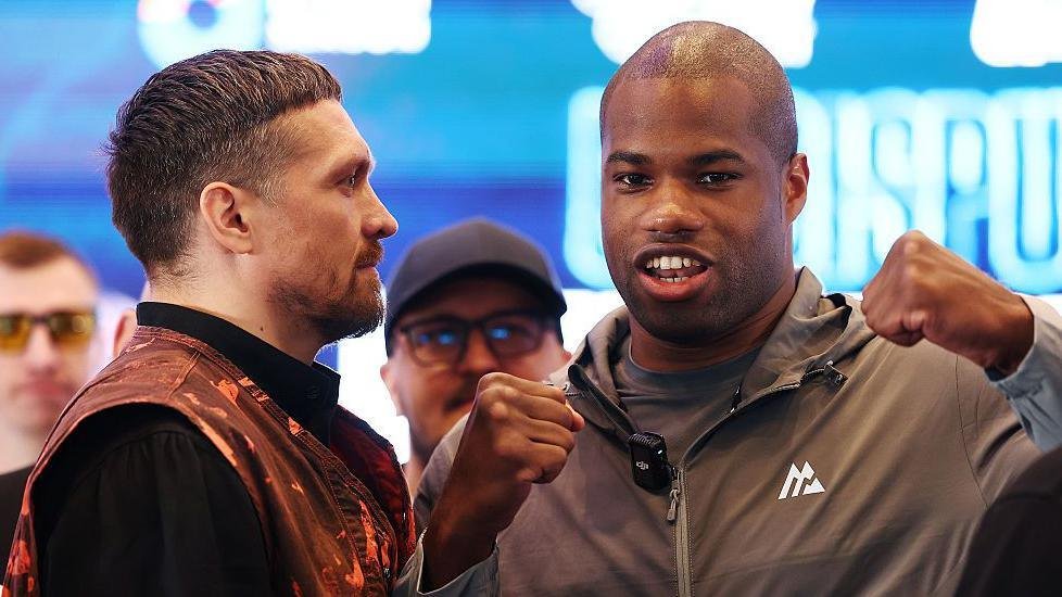 Oleksandr Usyk stares at Daniel Dubois after he looks away from a face-off