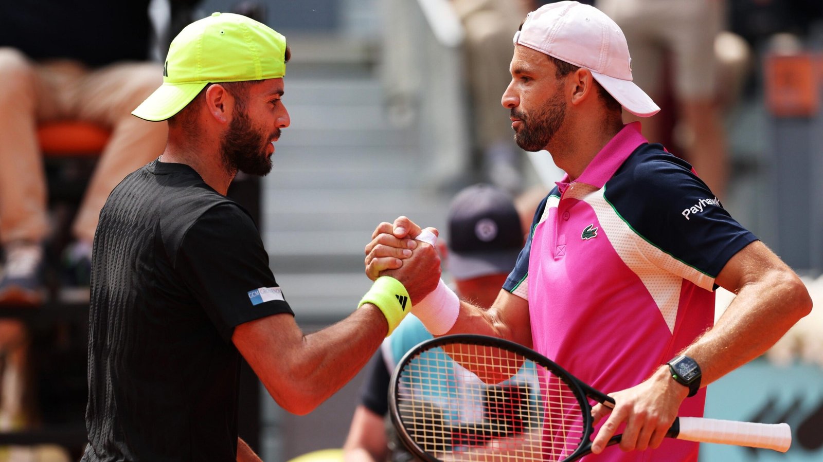Jacob Fearnley shakes hands with Grigor Dimitrov at the Madrid Open