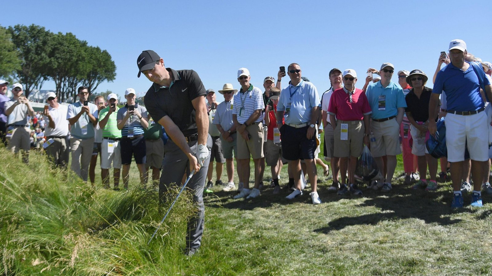 Rory McIlroy hitting the ball out of the rough during a practice round for the 2016 US Open at Oakmont